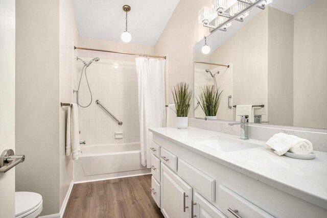 full bath with vanity, shower / bathtub combination with curtain, wood finished floors, and toilet