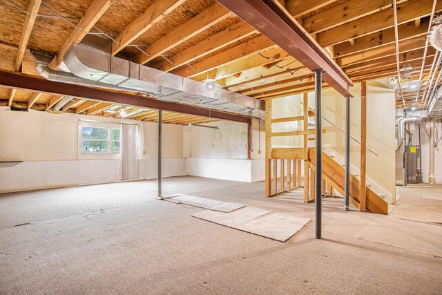 basement with stairs and water heater