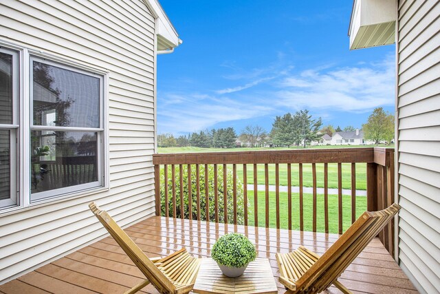 wooden terrace featuring a yard