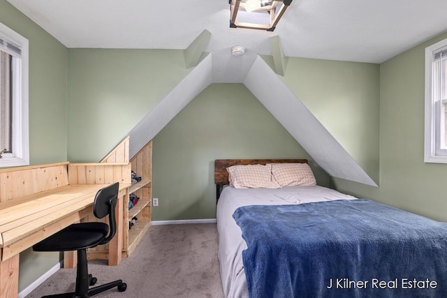 bedroom with baseboards, carpet flooring, vaulted ceiling, and multiple windows