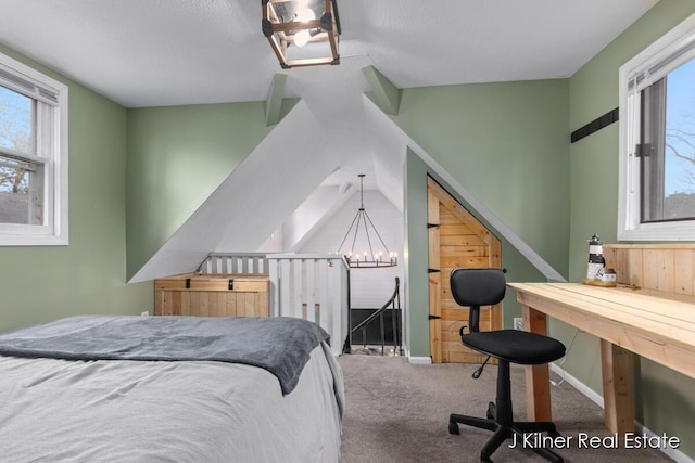 carpeted bedroom featuring a notable chandelier
