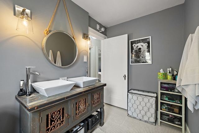full bathroom with a sink and double vanity