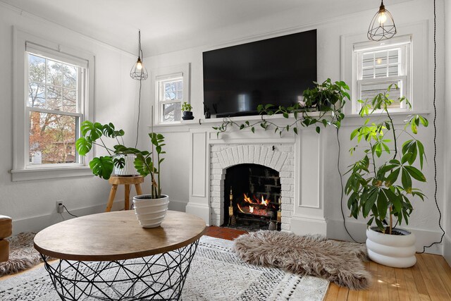living area featuring a brick fireplace