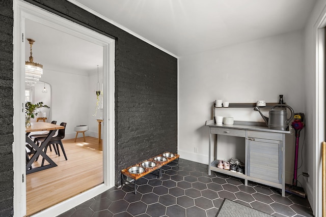bar with dark tile patterned flooring and baseboards