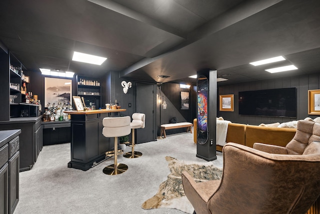 bar with wooden walls, visible vents, light carpet, and a bar