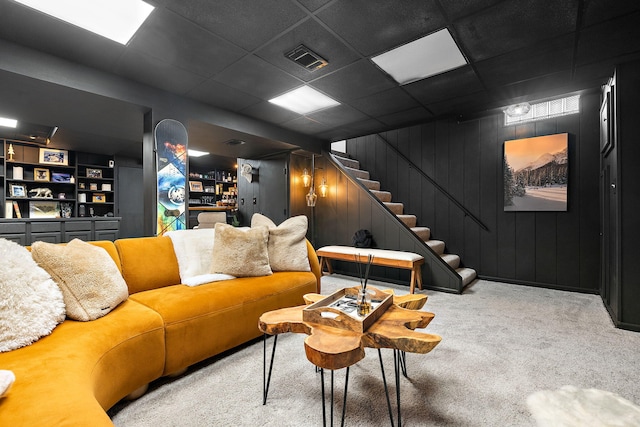 living area with carpet floors, stairs, built in shelves, and visible vents