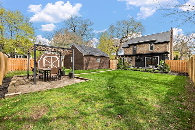 view of yard featuring a fenced backyard, an outbuilding, a patio area, and a shed