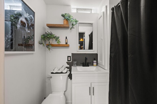 full bathroom with a healthy amount of sunlight, vanity, and toilet