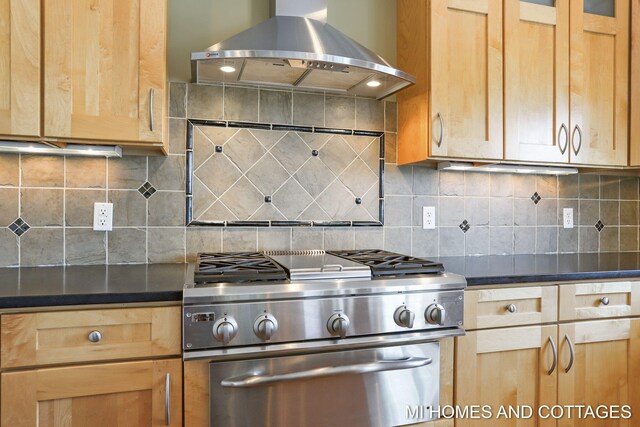 9145 Winterberry Dr, West Olive, MI 49460 - kitchen with island exhaust hood, range, dark countertops, and light brown cabinets