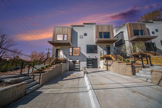 205 Sunset Rd, Ann Arbor, MI 48103 - contemporary house featuring a garage, concrete driveway, and stairway