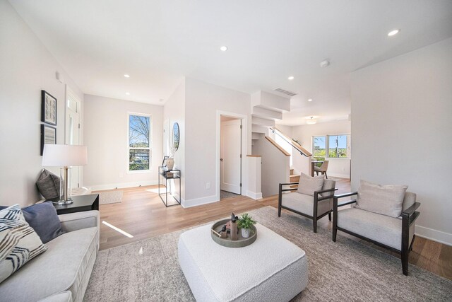 205 Sunset Rd, Ann Arbor, MI 48103 - living area with visible vents, baseboards, stairway, recessed lighting, and light wood-style flooring