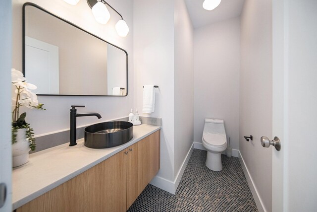 205 Sunset Rd, Ann Arbor, MI 48103 - half bath with toilet, baseboards, tile patterned flooring, and vanity