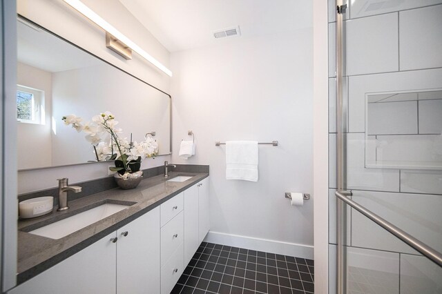 205 Sunset Rd, Ann Arbor, MI 48103 - bathroom featuring a sink, baseboards, tile patterned flooring, and visible vents