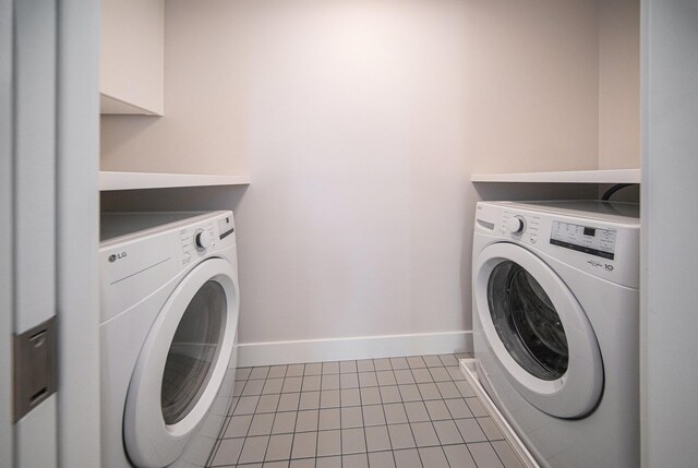 205 Sunset Rd, Ann Arbor, MI 48103 - washroom featuring separate washer and dryer, baseboards, laundry area, and tile patterned flooring