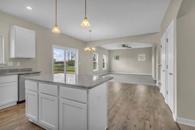 kitchen with a center island, white cabinets, ceiling fan with notable chandelier, and dishwasher