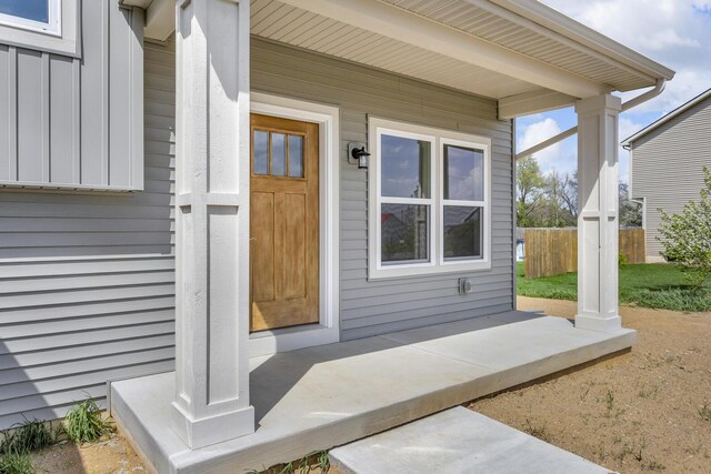 view of exterior entry with fence