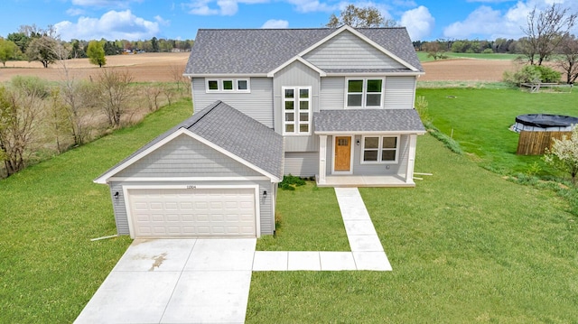 view of front of house with a garage, a shingled roof, a front lawn, and driveway