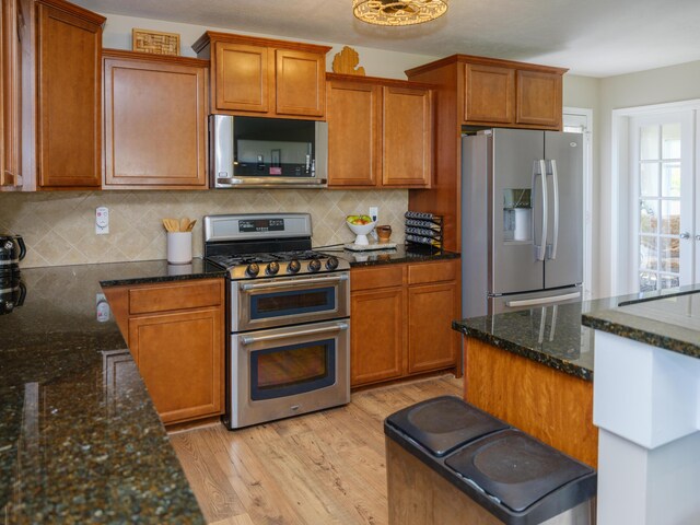 30777 Packard St, Paw Paw, MI 49079 - kitchen with stainless steel appliances, light wood-style flooring, and brown cabinetry