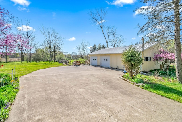 exterior space featuring a lawn, metal roof, and a garage