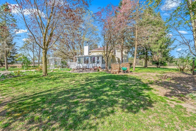 view of yard featuring a sunroom