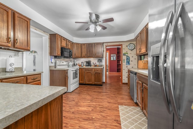 kitchen featuring light countertops, appliances with stainless steel finishes, ceiling fan, and wood finished floors
