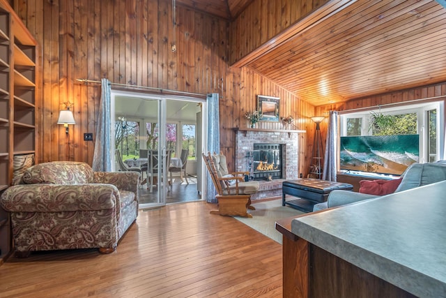 living room with wood walls, wood ceiling, vaulted ceiling, and hardwood / wood-style floors
