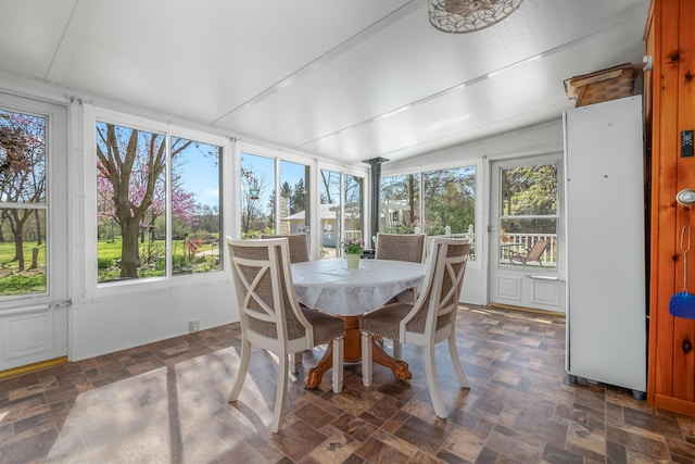 sunroom featuring plenty of natural light and lofted ceiling