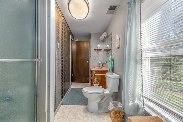 bathroom with a sink, toilet, and visible vents