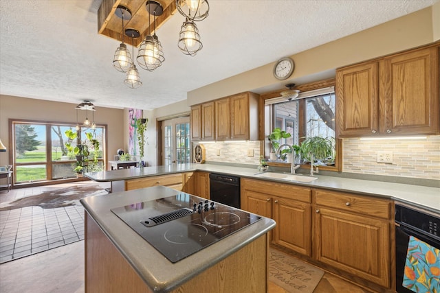 kitchen with a textured ceiling, a sink, black appliances, and tasteful backsplash