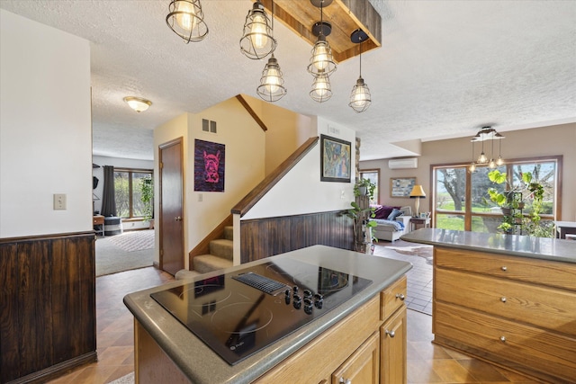 kitchen with visible vents, open floor plan, a textured ceiling, and black electric cooktop