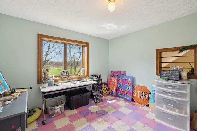 game room featuring a textured ceiling and tile patterned floors