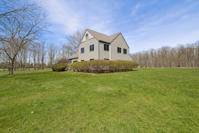 view of home's exterior with a yard