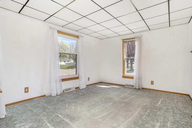 carpeted spare room with baseboards and visible vents