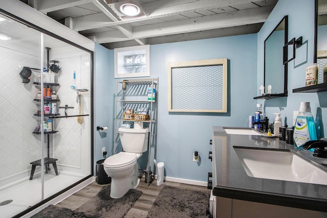 full bathroom with a shower stall, wood finished floors, vanity, baseboards, and toilet