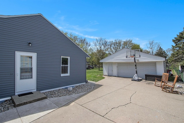 view of home's exterior featuring a garage and an outbuilding