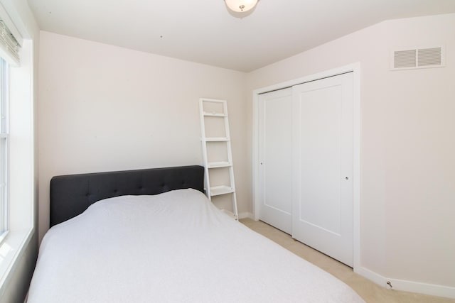 2841 Hardwick Rd, Ann Arbor, MI 48105 - bedroom with baseboards, light carpet, a closet, and visible vents