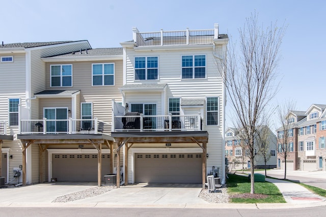 2841 Hardwick Rd, Ann Arbor, MI 48105 - multi unit property featuring concrete driveway, an attached garage, cooling unit, and a balcony