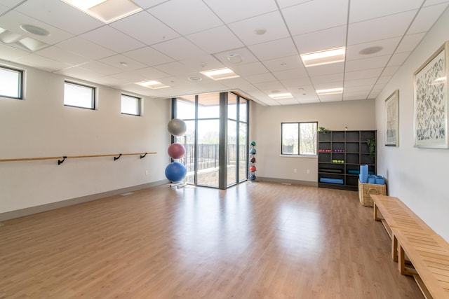 2841 Hardwick Rd, Ann Arbor, MI 48105 - workout area featuring baseboards, a paneled ceiling, and light wood-style flooring