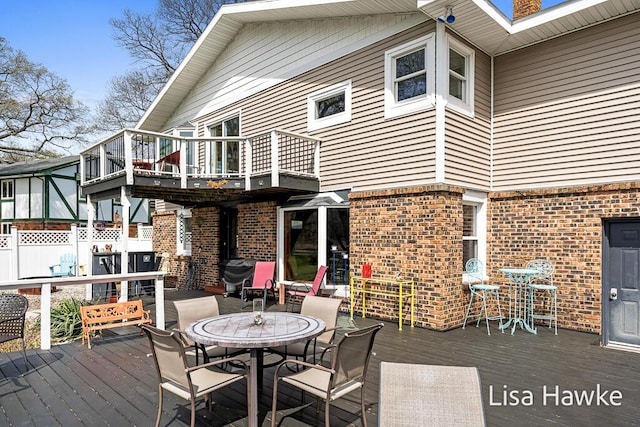 wooden terrace with outdoor dining area