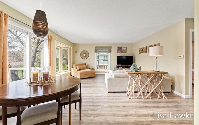 living area with baseboards and light wood-style flooring