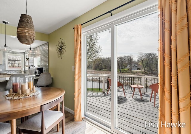 doorway to outside with light wood-style floors