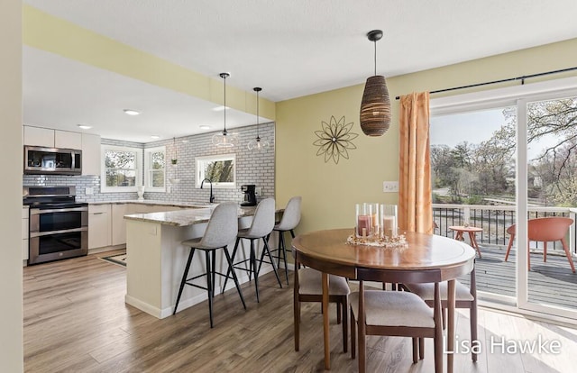 dining space with light wood finished floors