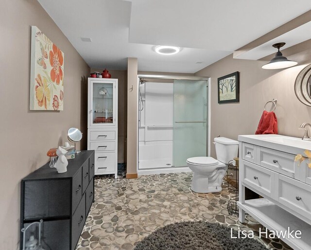 full bath with vanity, toilet, and a shower stall
