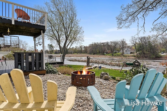view of patio / terrace featuring a fire pit and a deck with water view