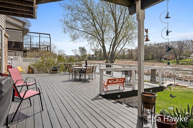 wooden terrace with outdoor dining space