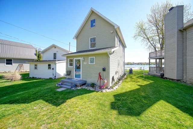 5576 Rays Dr, Onsted, MI 49265 - back of house featuring a lawn and a water view