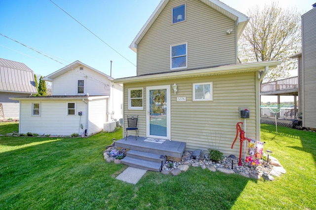 5576 Rays Dr, Onsted, MI 49265 - back of house featuring a lawn and cooling unit