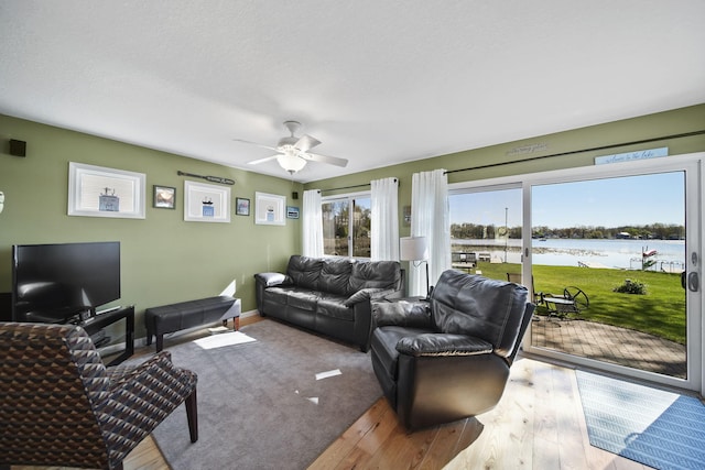 5576 Rays Dr, Onsted, MI 49265 - living area featuring baseboards, a water view, a ceiling fan, and wood finished floors