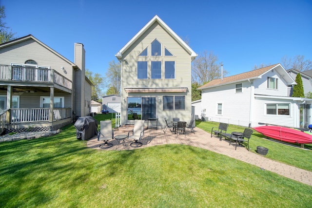 5576 Rays Dr, Onsted, MI 49265 - back of property with a lawn and a patio