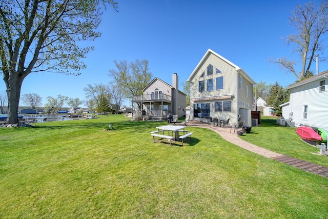 5576 Rays Dr, Onsted, MI 49265 - rear view of property featuring a lawn, a patio, central air condition unit, and a deck